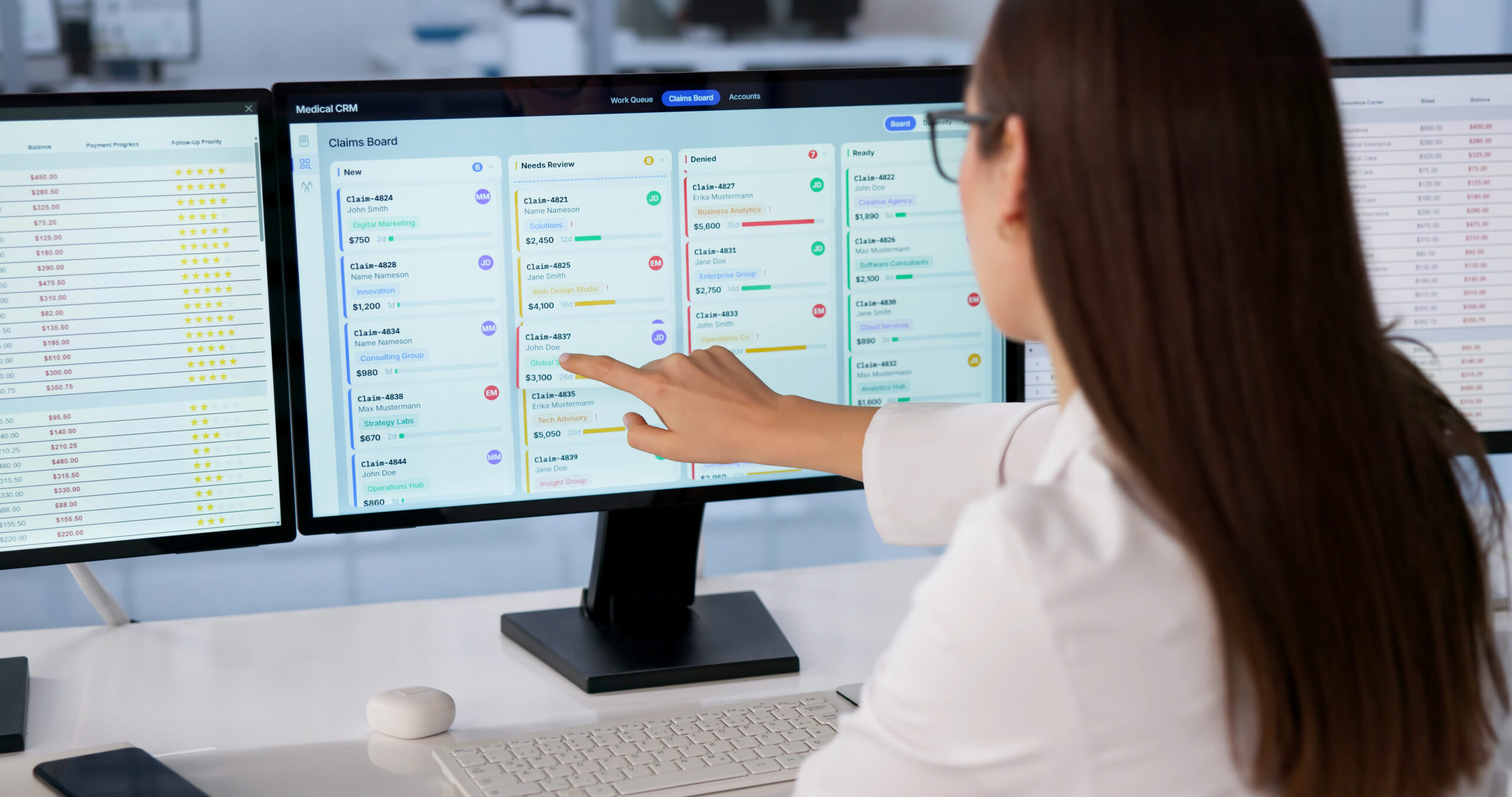 Healthcare professional reviewing EHR workflow and task lists across multiple computer screens